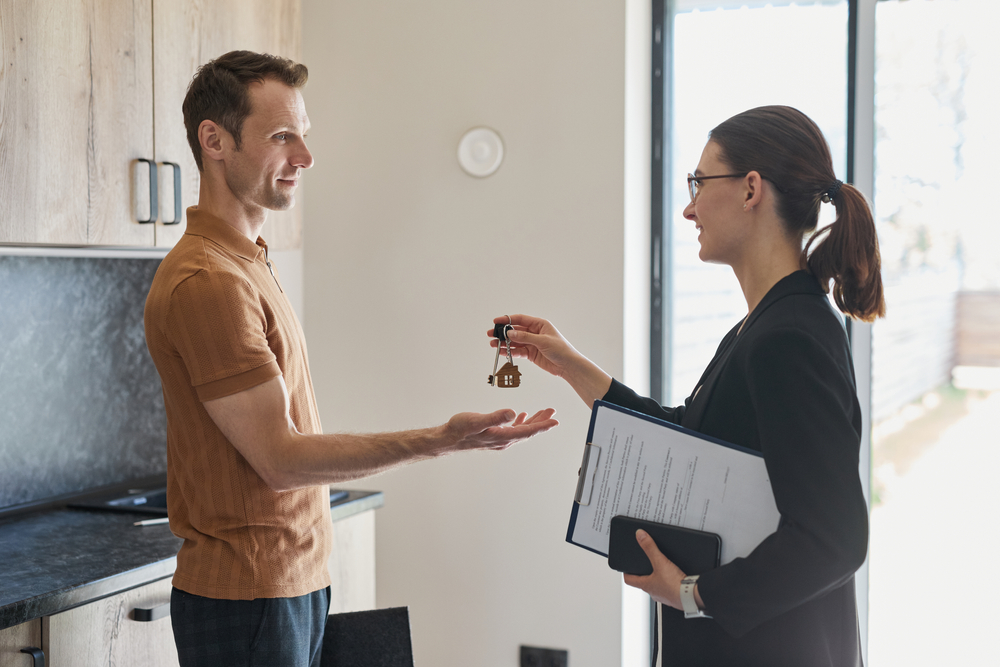 real estate agent giving keys to new property owner