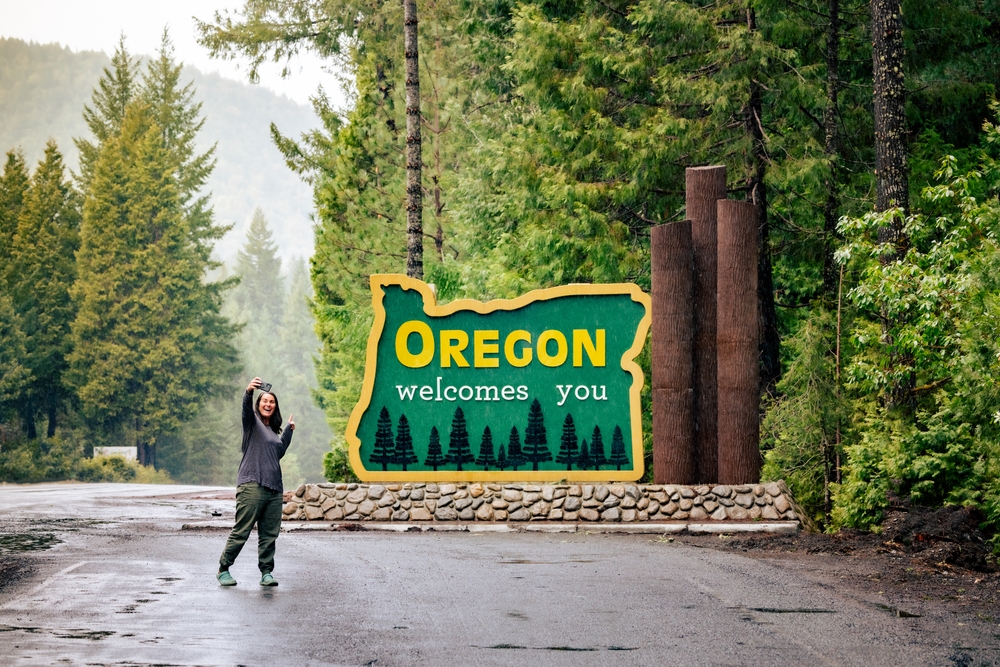 welcome to oregon sign, oregon welcomes you, woman, forested road